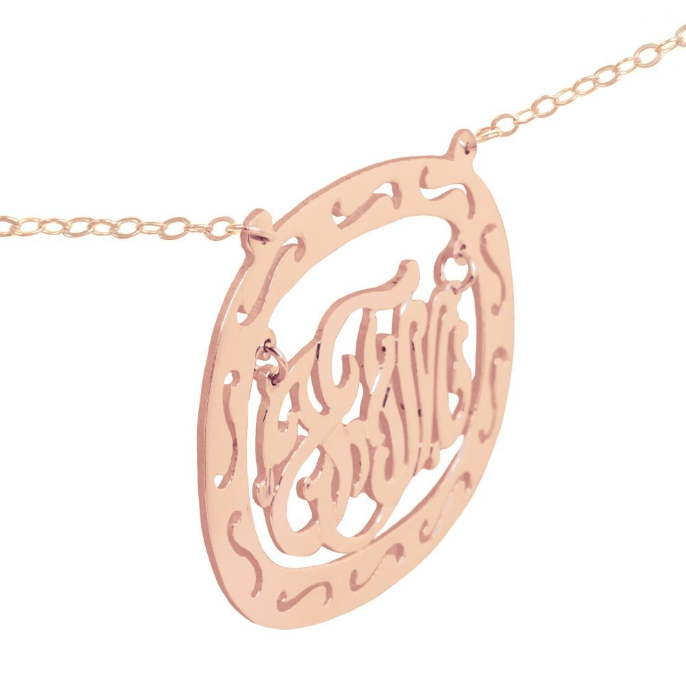 14K rose gold-plated silver oval monogram necklace inside thick patterned circular frame Angle