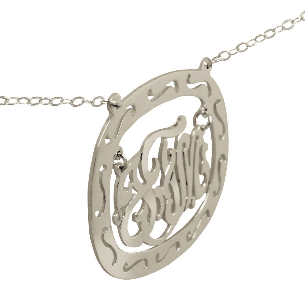 silver oval monogram necklace inside thick patterned circular frame Angle